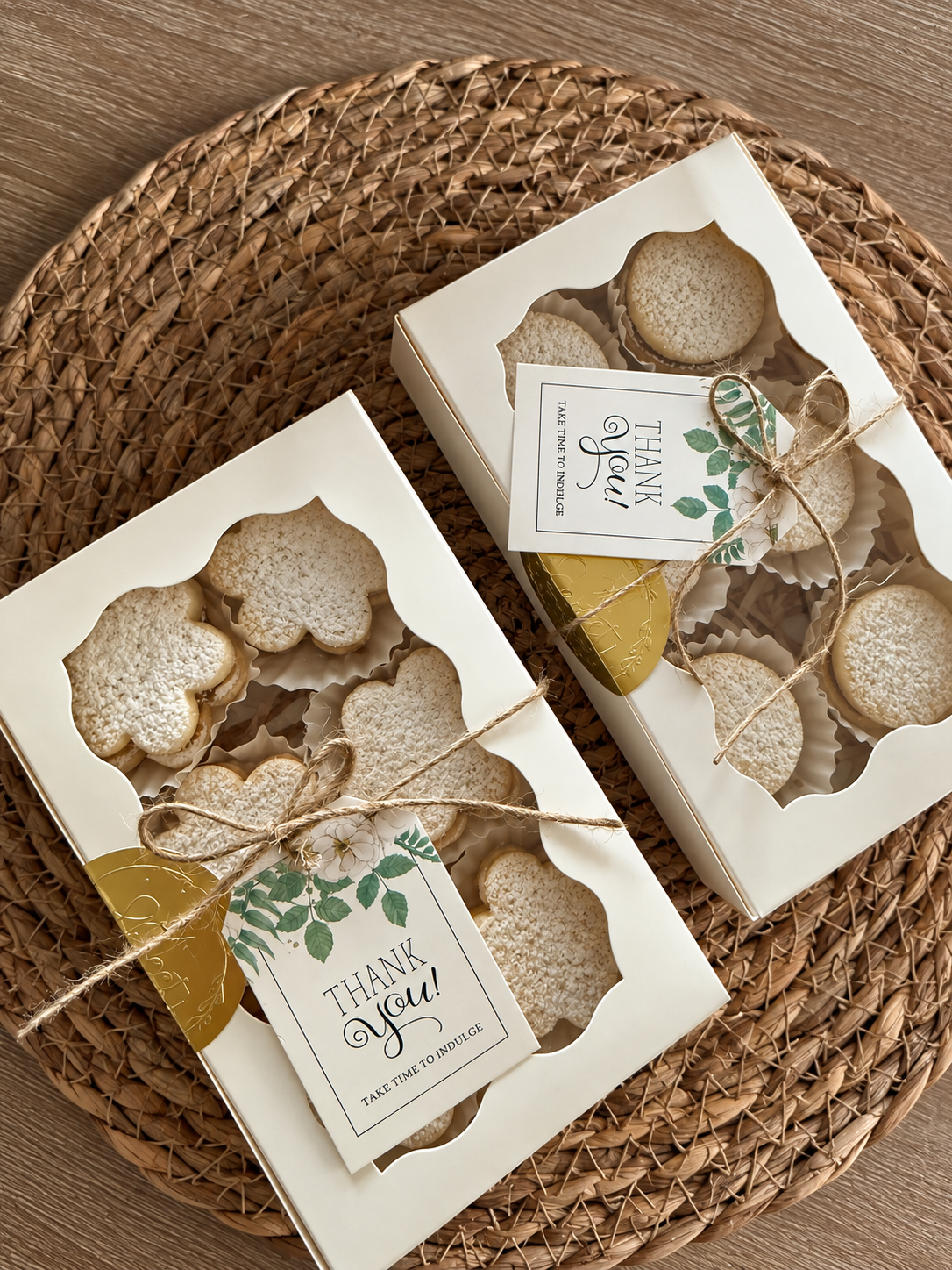 Sunny Mellow gift boxes of round and flower-shaped alfajores on a woven placemat in Dallas